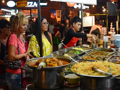 Bangkok, Thailand - March 2, 2023 - Tourists and backpackers visited at Khao San Road night market. Khao San Road is a famous low budget hotels and guesthouses area in Bangkok.
