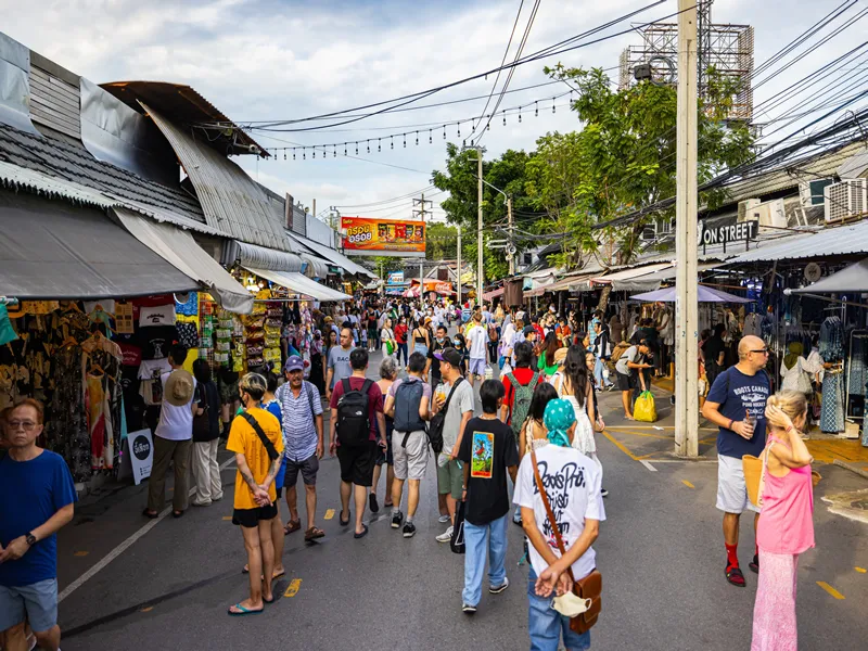 Bangkok, Thailand - November 11, 2023: Throngs of visitors explore the bustling Chatuchak Weekend Market, wandering among countless stalls and vibrant signs in a dynamic shopping environment