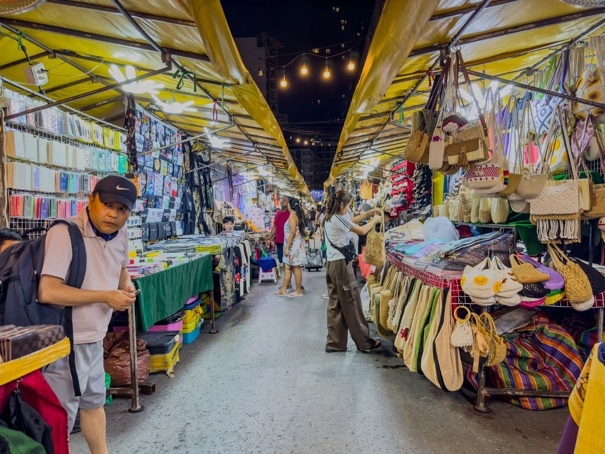 Sunday 23 June 2024 Patpong night market in Silom Bangkok BKK at night colourful neon lights of the clubs and bars and vendors selling their stock