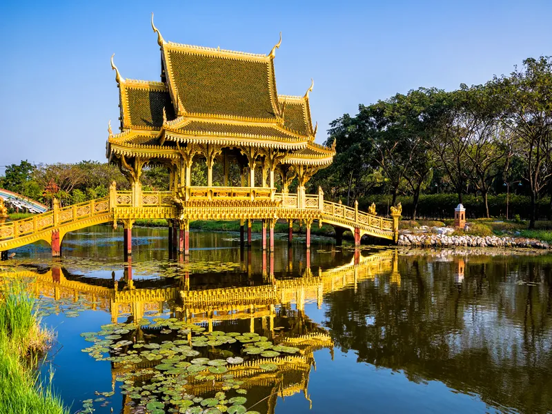 Beautiful Golden Bridge and Pavilion of the Enlightened with reflection in the water. Location: Ancient City Park, Muang Boran, Samut Prakan province, Bangkok, Thailand. Beauty world