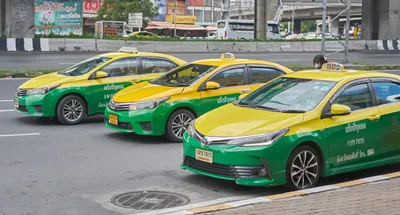 Editorial use only; three colorful taxi cabs in a row, taken in Bangkok, Thailand, on October 26th, 2023.