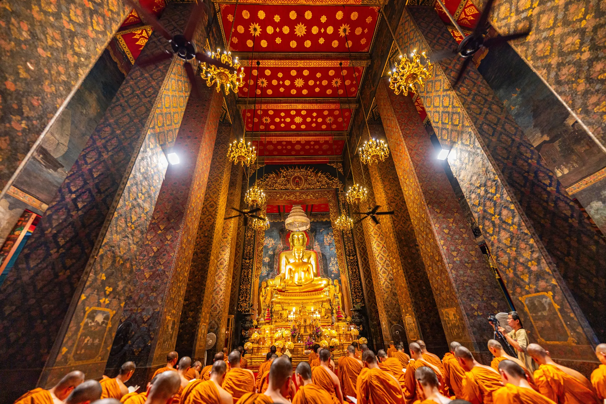 Bangkok,Thailand, April 10,2024 : Monks pray in front of the main Buddha image in the chapel of Wat Bowonniwet Vihara. stillness of mind Spread religion and study Dhamma. golden Buddha statue